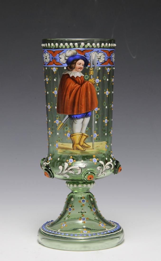 Moser Glass with Soldier: Light green glass enameled with decorative patterns with the depiction of a soldier on the side. Dimensions are: 8" tall, 3 1/4" in dia. All measurements are approximate. Condition: Some wear is visib