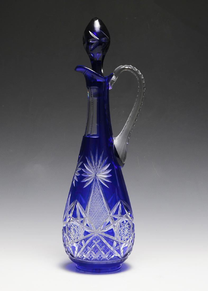 Cobalt Cut to Clear Ewer: Unmarked, probably 19th century Czech ewer. Stopper has faceted end. Dimensions are: 15 5/8" tall. All measurements are approximate. Condition: Small chip to faceted end of stopper. Fine - Very Fine.