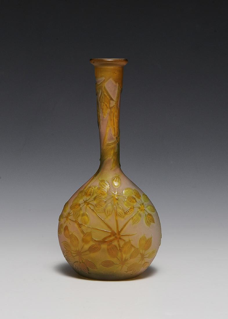 Yellow Galle Vase with Poppies: A signed Galle banjo-shaped, bud vase decorated with closed poppy flowers. The vase is in light orange overlaid with yellow. Original paper label. Dimensions are: 6 3/4" tall. All measurements are app