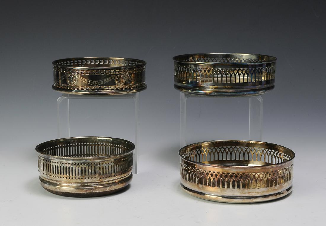 Four Silver Plate Edwardian Wine Coasters: One is marked Made in Sheffield, two marked EPB, and one is marked Stieff. Dimensions are: Largest - 5 3/8" dia. All measurements are approximate. Condition: No noted damage. Excellent.