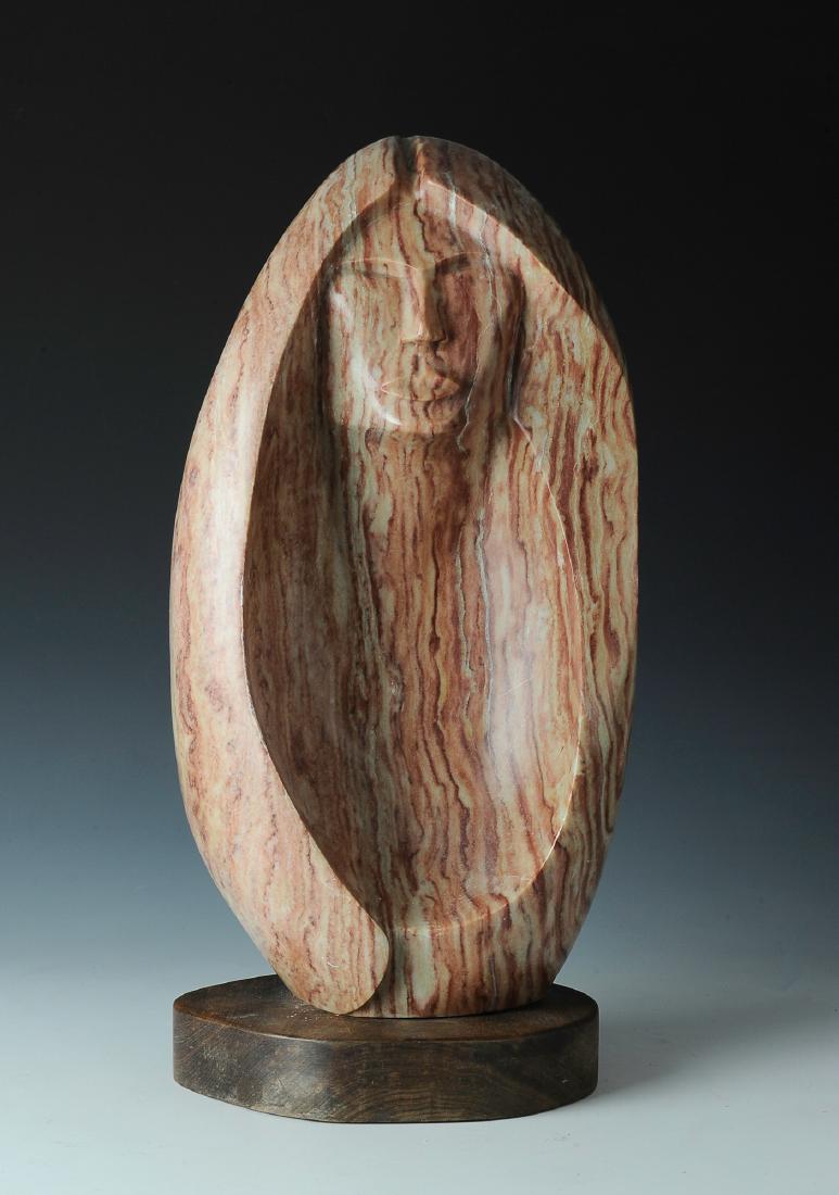 Alabaster Sculpture of Woman by Lorne Fineday: The sculpture is in pink alabaster and is of a stylized woman's face. The artist is Lorne Fineday (Canadian, born 1951), a First Nation artist who draws inspiration from traditional Cree legends. It i