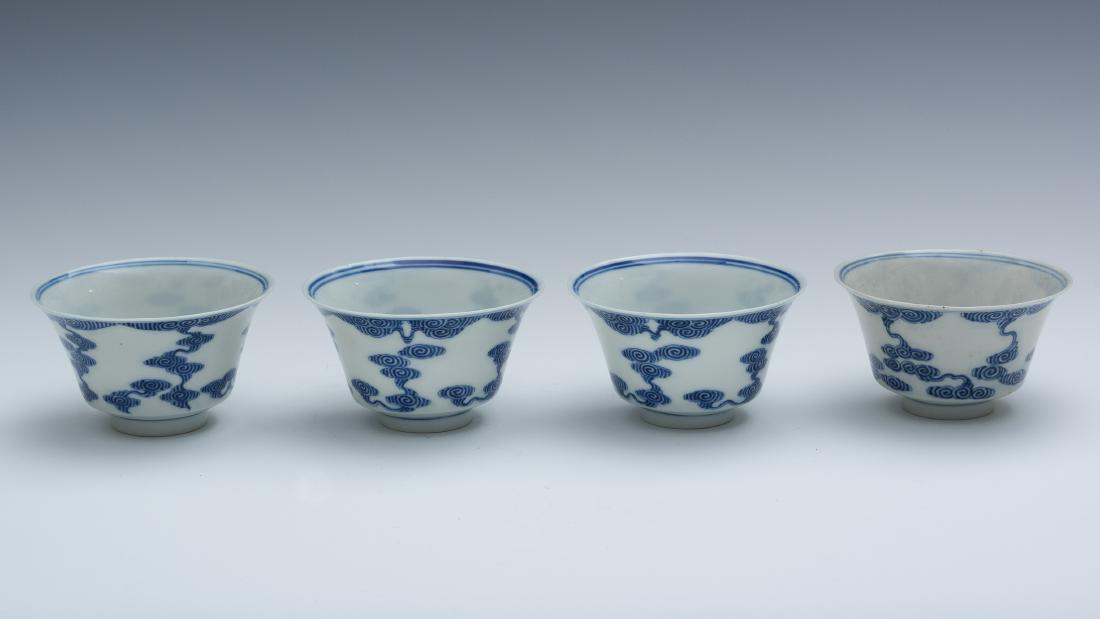 Chinese Set of 4 Blue & White Tea Cups, Late Qing: A set of 4 Chinese blue and white porcelain tea cups decorated on the interior and the exterior with ruyi-shaped clouds. Each has a 6-character mark on the bottom and they are from the late Qing dynas