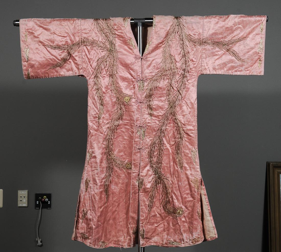 Pink Silk Korean Robe with a Phoenix c. 1940: Pink silk Korean robe dating to circa 1940, couch-stitched with a gold design of a phoenix. Dimensions are: 46" tall x 48" wide. All measurements are approximate. Condition: The silk is cracked and sp