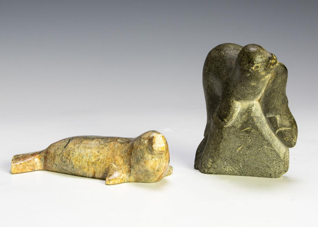 (2) Eskimo, Hand-Carved Sculptures, Soapstone: Two seal soapstone sculptures and one bone sculpture group. One soapstone sculpture retains sticker from the Canadian government certifying that it was made by an Eskimo artist. Dimensions are: larges