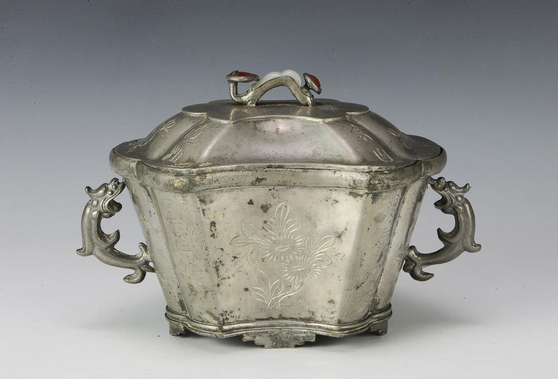 Chinese Metal Warmer w/ Ruyi Lid: A Chinese soft metal 3-part warmer with a ruyi wand finial with a small piece of white jade. The exterior of the body and the lid have inscriptions and flowers. There is a 4-character motif on the bot