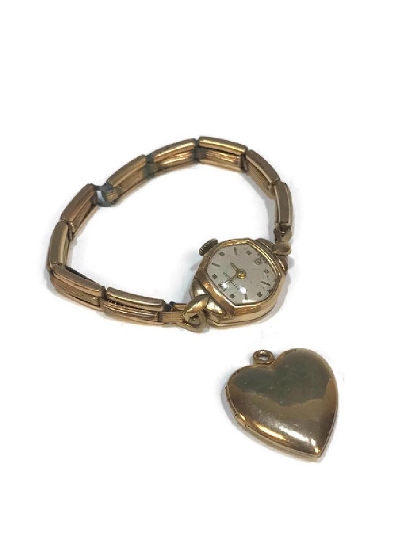 Wittnauer Watch with 14K Gold Case & Locket: Wittnauer Watch with 14k Gold Case & Locket: a) Wittnauer Watch with 14k Gold Case. b) 10k yellow gold, heart shaped, locket. Total weight of locket: 3.7 g (0.11 troy oz). Dimensions are: locket - 78"