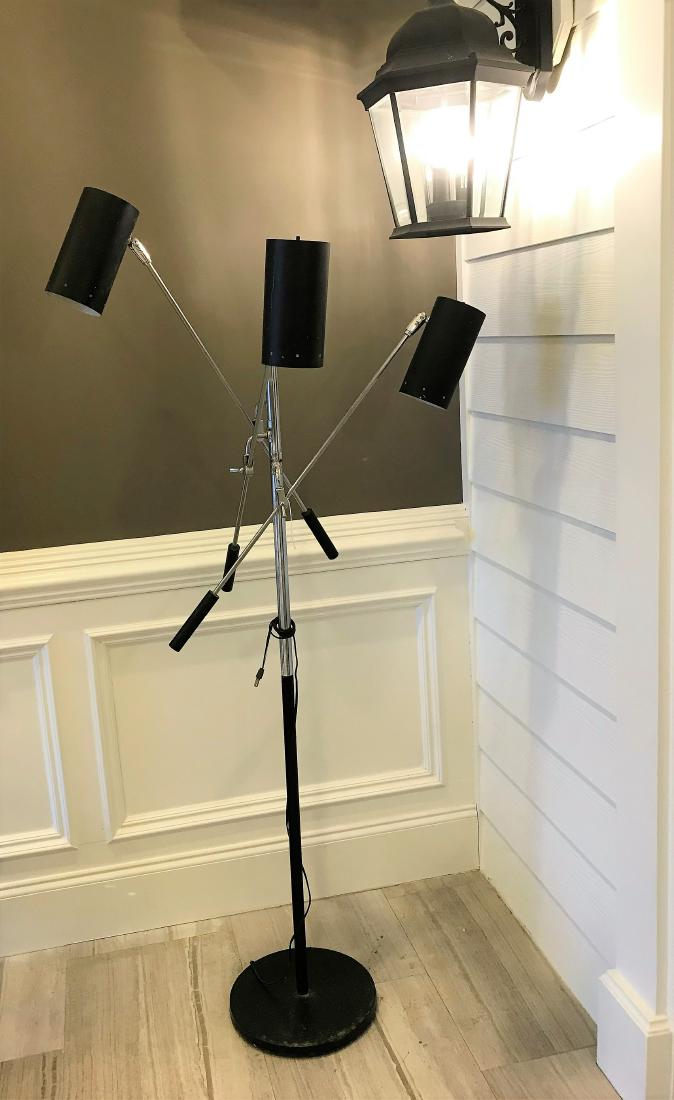 Mid-Century Adjustable Chrome Floor Lamp: Mid-Century Adjustable Floor Lamp in the style of Arredoluce. Circular black base supports a chrome column with three arms terminating with adjustable black can lights. Dimensions are: 60" tall. All m