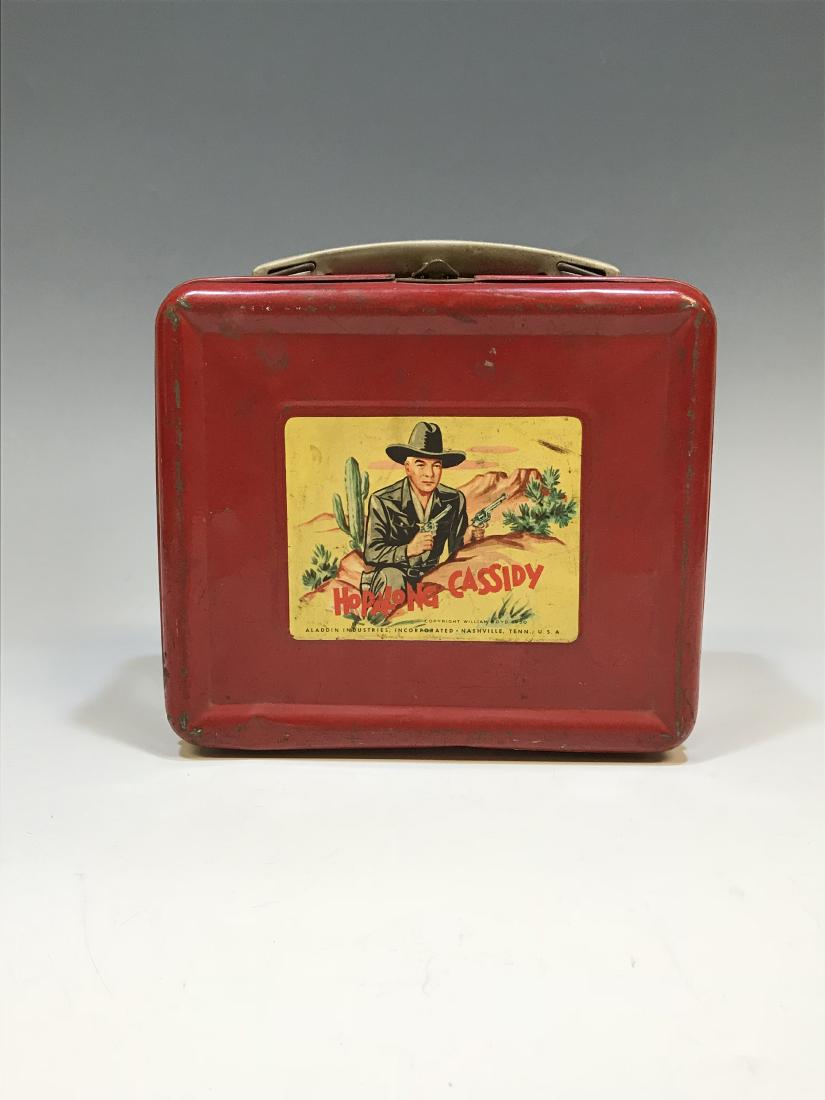 Hopalong Cassidy Red Metal Lunch Box: Hopalong Cassidy Red Metal Lunch Box: American, circa 1950s, Aladdin Industries. Dimensions are: 8" high X 7" wide X 4" deep. All measurements approximate.