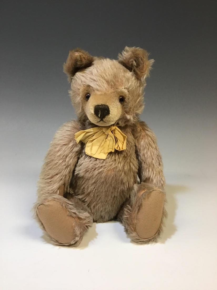 1950s Steiff Jointed Body Bear with Ear Button: 1950s Steiff Jointed Body and Head Teddy Bear with Ear Button: American. Dimensions: 14"h. All measurements are approximate. Condition: Free of rips, tears and repairs but with age associated wear.