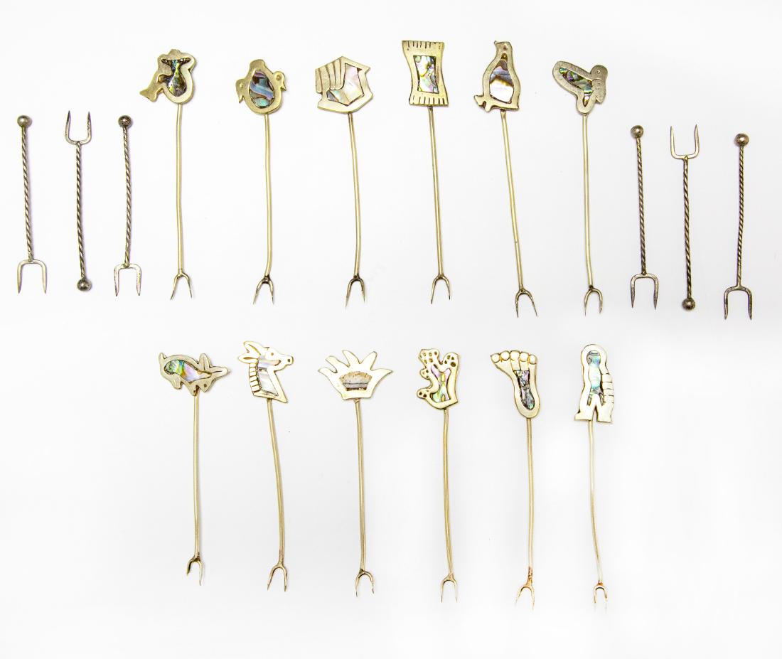 (18) Alpaca Silver Cocktail Forks Abalone Animals: Twelve alpaca or nickel silver cocktail forks with mother of pearl inlaid handles in shape of animals, plus six cocktail forks tested sterling. Nickel silver forks marked "Alpaca" on the back of the h