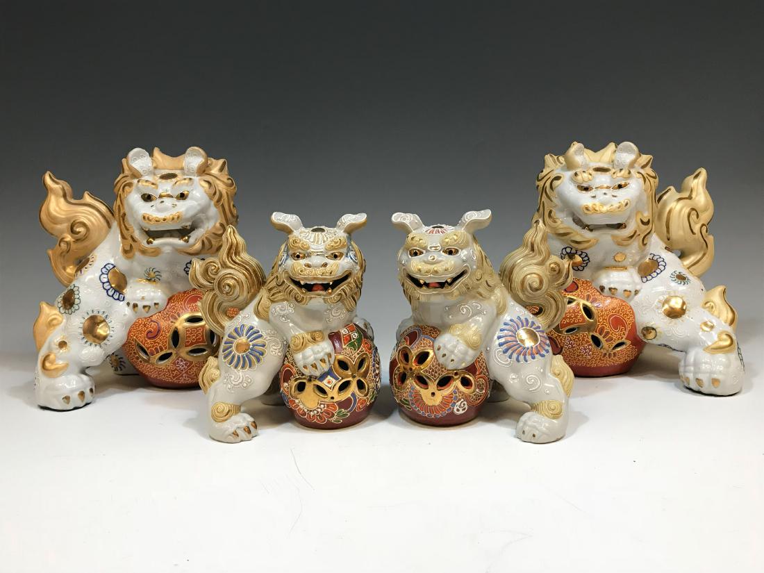 (4) Japanese Satsuma Foo Dogs White & Gold: Two pairs of Japanese Satsuma ceramic foo dogs, all painted white with gold manes and decorated with patterns in blue, gold, and red. Dimensions are: larger Foo dogs - 7" tall X 8" wide X 9 1/4" long,