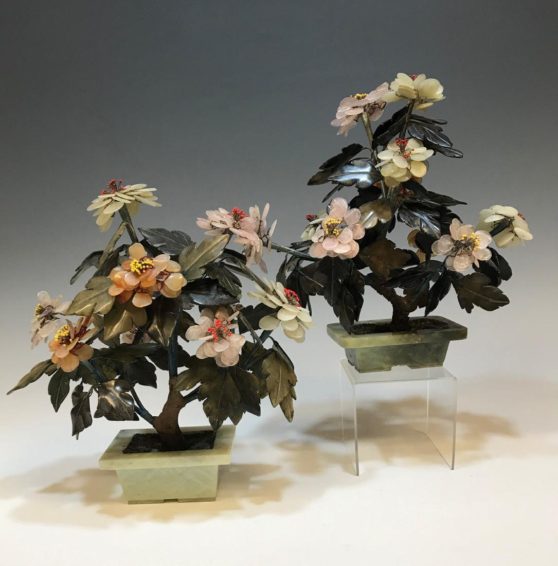 (2) Stone & Glass Flowers in Stone Flowerpots: Pair of decorative stone and glass flower arrangements in green stone pots. Flowers are made of pink, orange, and white stone or glass. Dimensions are: 12" tall X 11 1/2" wide X 6 1/2" deep. All measu