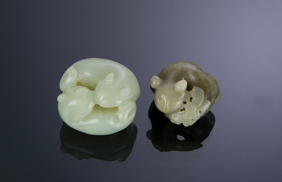 Set of 2 Jade Carvings of Cats, 18th-19th Century: A pair of jade carvings of felines dating from the 18th to 19th centuries. There is a butterfly carved on one side of one carving while the other carving features a pair of felines. Dimensions are: th