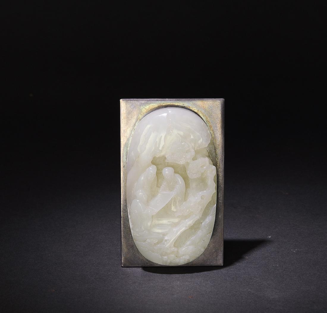 Chinese White Jade Ruyi Head, 18th-19th Century: A Chinese jade ruyi head dating from the 18th to the 19th century. The ruyi head is carved with Fu, Lu, and Shou unveiling a yin-yang medallion in a mountain cave surrounded by pine trees. The jade is