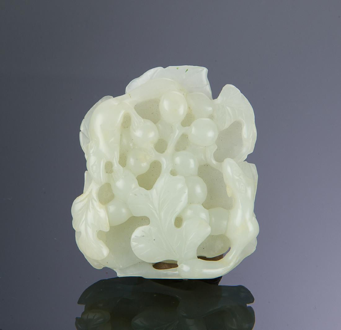 Chinese White Jade Carving of Squirrels, 18th C.: A Chinese white jade carving of two squirrels among bunches of grapes and leaves dating from the 18th century. Dimensions are: 2 1/2 inches tall X 2 inches wide. All measurements are approximate. Cond