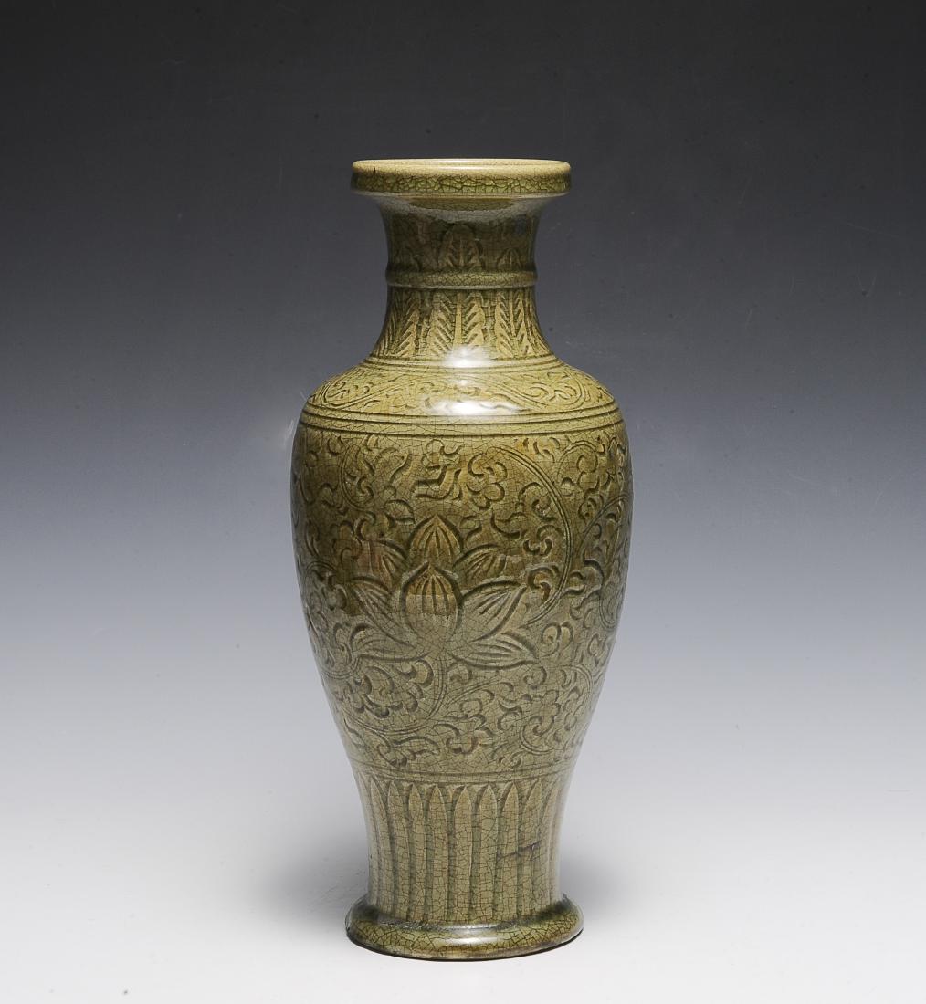 Chinese Celadon Longquan Vase, Ming Dynasty: A Chinese longquan celadon vase dating from the Ming dynasty. The vase is incised with banana leaves and a raised string pattern at the neck, a banana leaf border at the base, and the main body depict