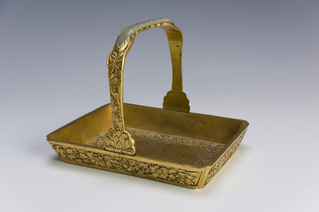 Gilt Bronze Plate w/ Inlaid Jade, 18th Century: A gilt bronze tray with a jade inset in the handle dating from the 18th century. Dimensions are: 4 1/2 inches tall X 5 1/2 inches wide. All measurements are approximate. Condition: It is in good condi