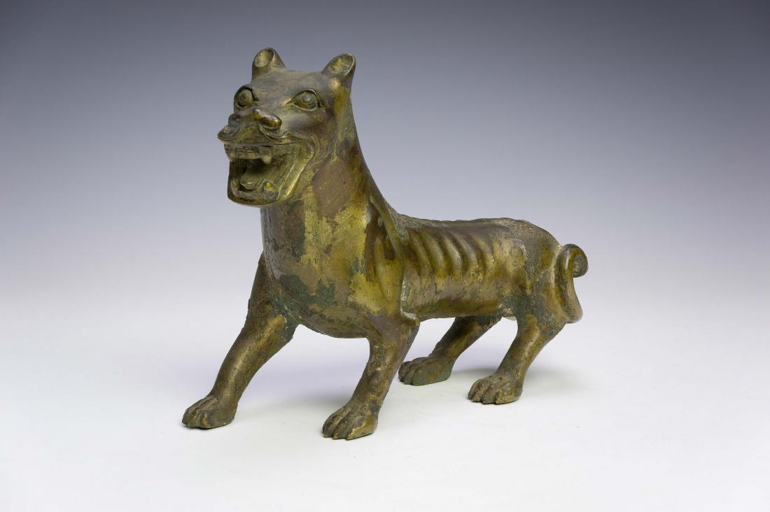 Chinese Gilt Bronze Beast, Ming Dynasty or Earlier: A Chinese gilt bronze beast dating from the Ming dynasty or possibly even earlier. Dimensions are: 5 inches tall X 7 inches wide. All measurements are approximate. Condition: There is significant age 