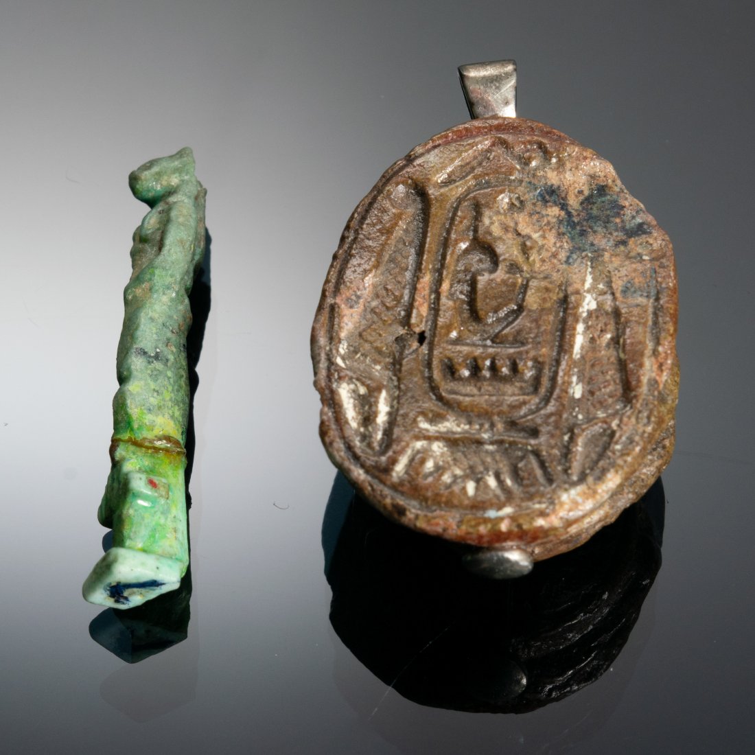 (2) Ancient Egyptian Relics - Ex. Ernest Freemark: Group of (2) Ancient Egyptian relics. a) Scarab, Seti I, 1313-1292 BC. b) Small faience figure of Bast circa 88 BC. Both pieces come with Freemarks notes on the bags the pieces were in. Dimensions are