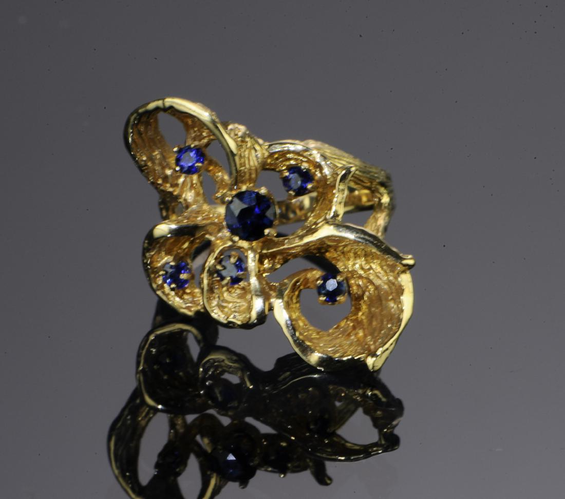 14K Gold Freeform Cocktail Ring with Sapphires: 14K gold cocktail ring with sapphires, circa 1960s. The free form, tooled band prong set with five sapphires, the largest 4mm x 4mm, Impressed, '585 14K', size 6.25, weight: 7.3 g, .23 ozt. All measur
