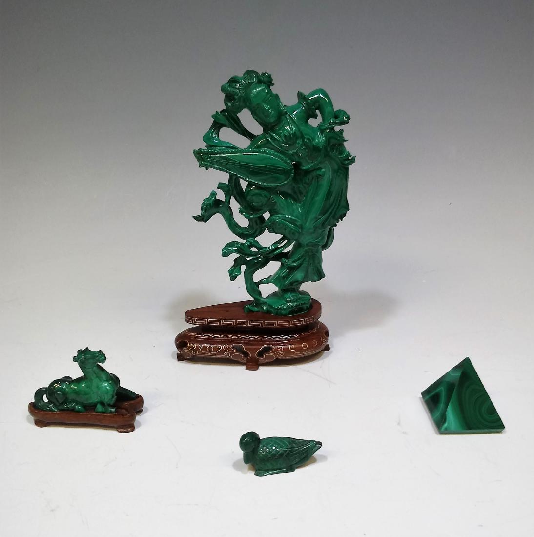 (4) Chinese Malachite Carvings Figure & Horse: Group of 4 malachite carvings including a pyramid, a duck, a horse and a lady with an instrument. Dimensions are: 2 1/4" x 2 5/8" for the pyramid, 6 3/8" x 4 1/8"for the lady. Condition: The lady and