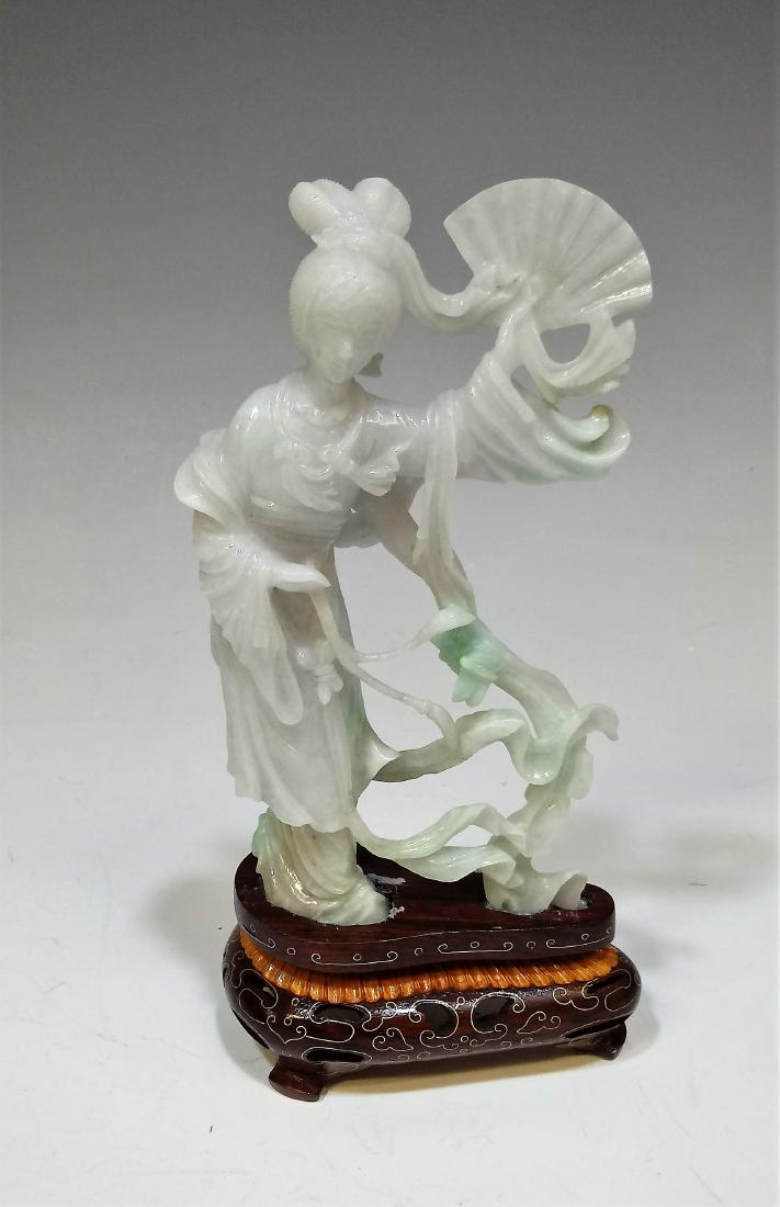 Chinese Jadeite Carving Woman w/ Fan & Stand: Chinese carved jadeite goddess holding a fan with a fitted decorative wooden stand. It comes with an old box. Dimensions are: 6 1/2" x 3 7/8". All measurements are approximate. Condition: There are so