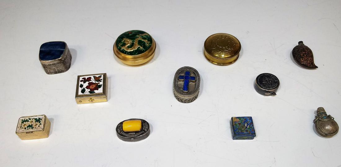Group of 11 Snuff and Pill Boxes: Group of 11 snuff, pill, and decorative boxes, of which 4 are enameled, two are repousse, three have inlaid stones - one with an advertisement within that claims the blue stone is lapis lazuli - and o