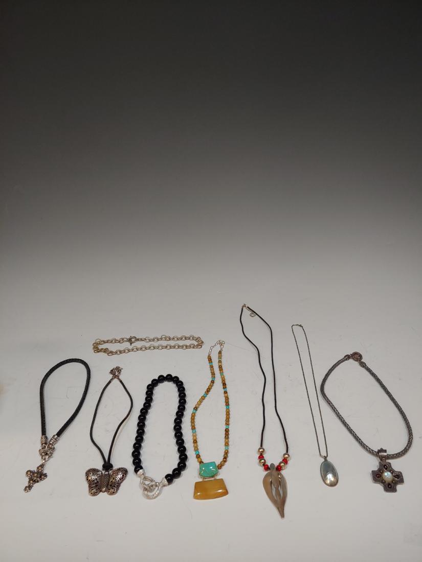 (7) Mixed Group of Sterling Pendant Necklaces: Onyx beads with sterling fittings by Judith Ripka, grey cord with sterling fittings and a sterling pendant/pin with carnelian & quartz, black cord with sterling fittings and sterling & 14K gold flower