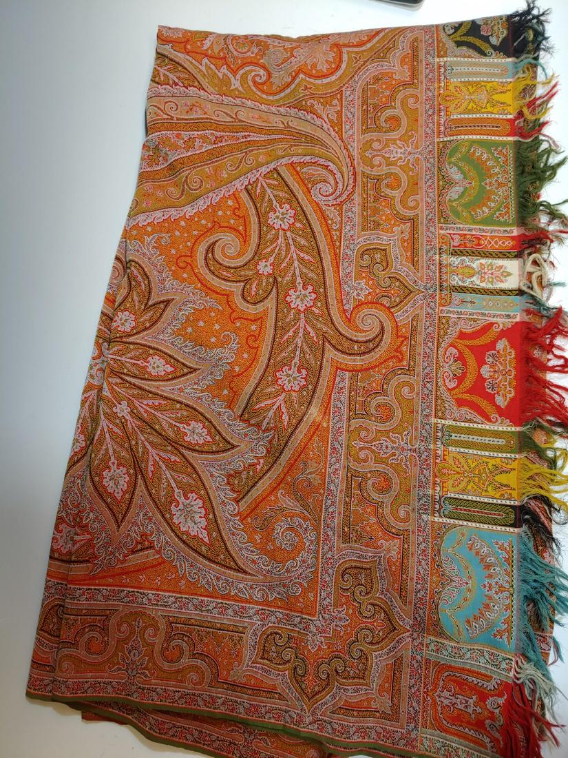 Brocade Twill Piano Shawl in Kashmir Pattern: Brocade twill weave wool piano shawl in orange, yellow, and black kashmir pattern, with fringe. Dimensions are: 67 inches wide X 141 inches long. All measurements are approximate. Condition: In good c