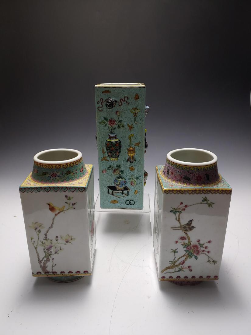 (3) Two Square Vases and a Hat Stand: Two square vases have a four character mark on the base and famille rose decoration along the top rim. Each side of both vases are decorated with birds and/or flowers. The hat stand is square with inc