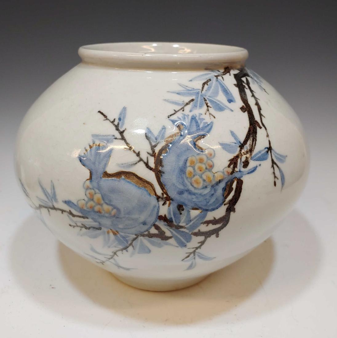 Korean Porcelain Pomegranate Moon Jar: Korean Pomegranate Moon Jar: Wheel thrown jar decorated with a branch of a pomegranate tree in blue and red on a white ground. Character signature on base. Dimensions are: 7 1/2 inches tall X 8 inches