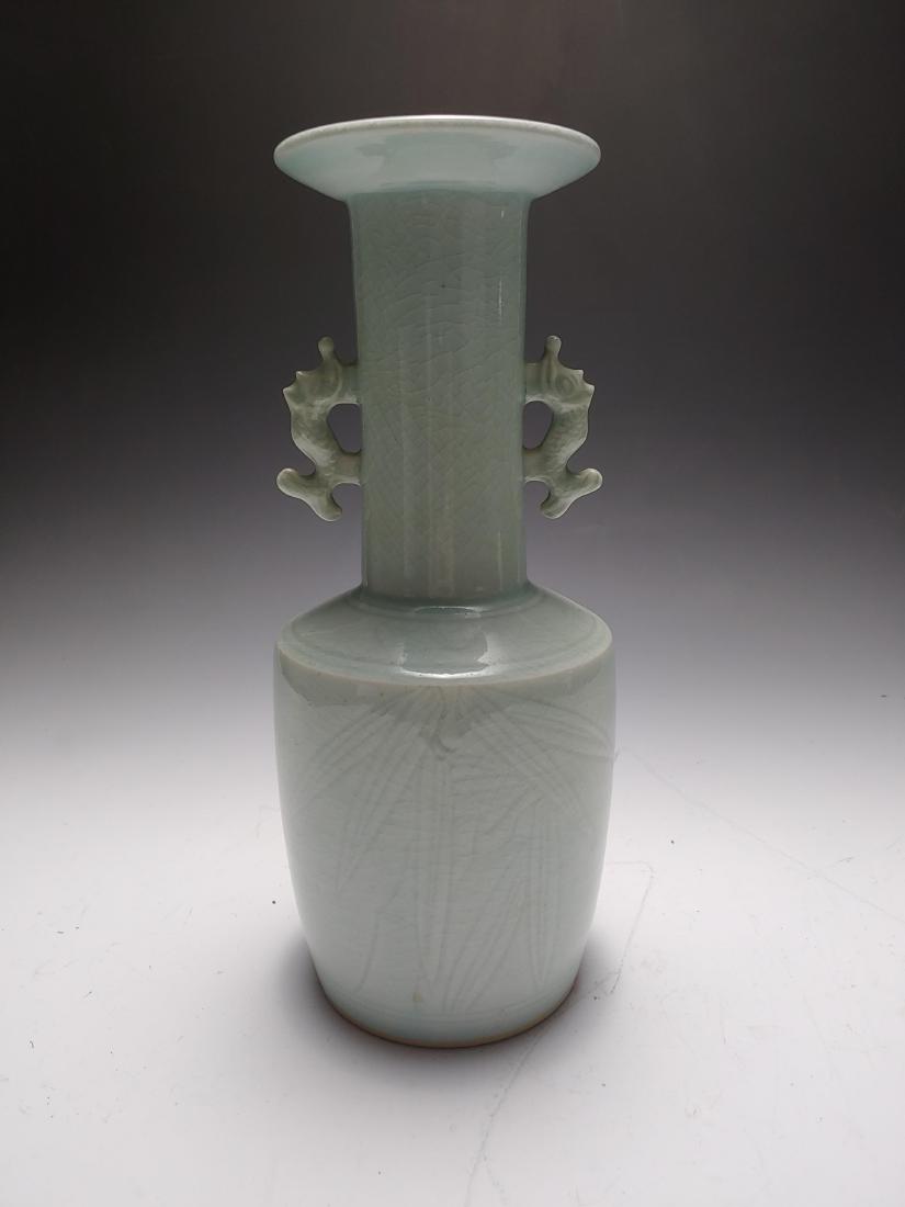 Korean Porcelain Celadon Vase with Bamboo: Pale celadon vase from Korea, circa 1960s. The vase has intentional craquelure and is incised with bamboo leaves on the body. It has two fish form handles on either side of its straight neck. Dimensio