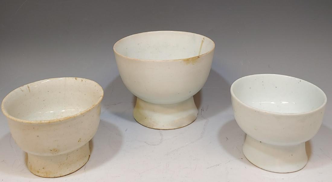(3) Glazed Footed Korean Bowls 16th - 17th Cent.: (3) Glazed Footed Korean Bowls 16th - 17th Cent.: All three are glazed white. Dimensions are: largest - 7 1/4 inches dia X 5 1/2 inches tall; middle size - 5 3/4 inches dia X 4 1/8 inches tall; smalle
