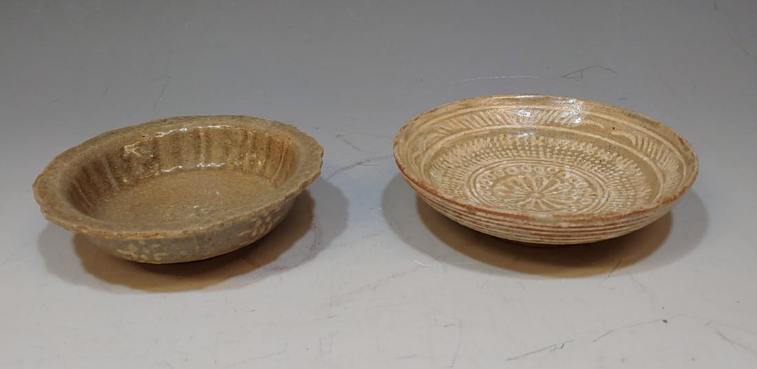(2) 12th -16th Century Korean Glazed Bowls: Round bowl has crackle glaze with incised decoration that is glazed white, and the flower form bowl has a crackle glaze with decorative motifs on the side in white. Dimensions are: round bowl - 4 3/4 