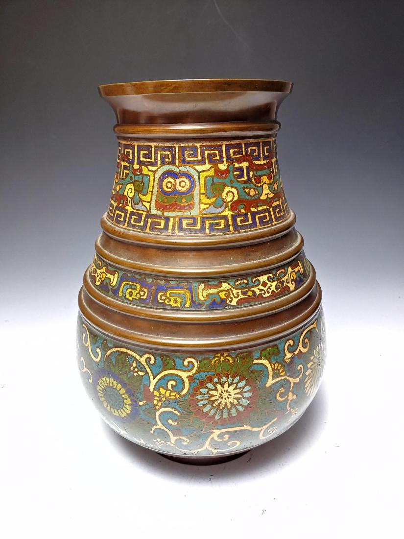 Japanese Cloisonne & Bronze Vase, Meiji Era: Japanese cloisonne and bronze vase from Meiji Era. The vase has three enamel bands of flowers and geometric designs alternating with bronze bands. The bottom has a diamond pattern and a stamped seal m