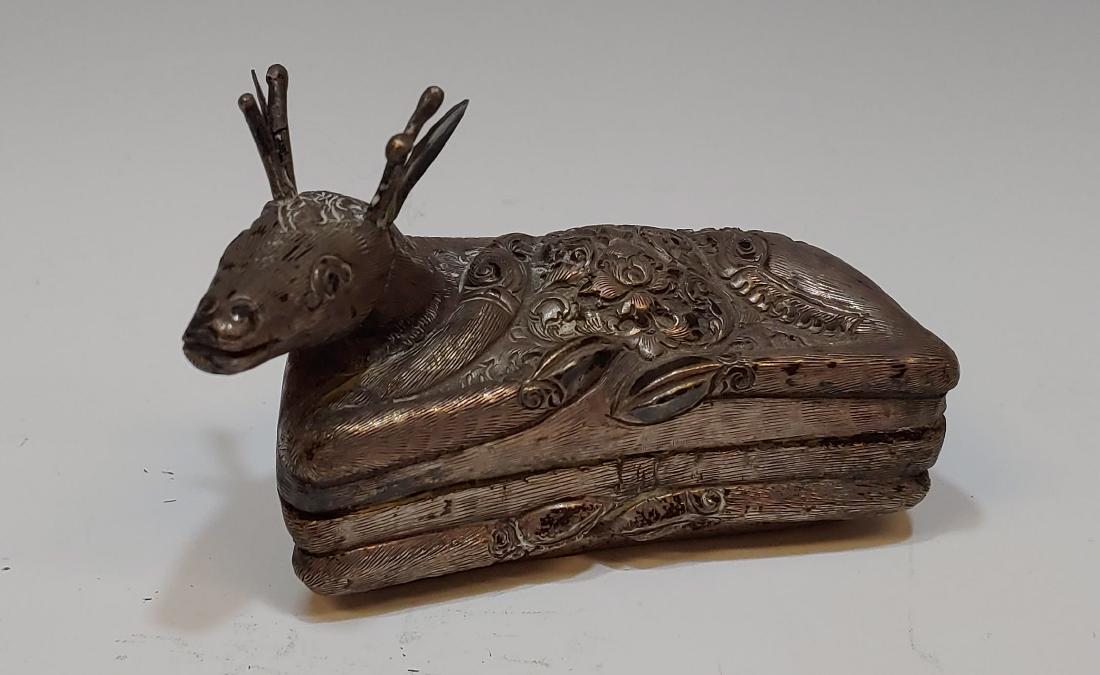 Reclining Cambodian Silver Deer Betel Nut Box: Reclining Cambodian silver deer betel nut box, with chased and repousse floral design in hide. Bottom of box inscribed with "90" and "90%", indicating silver content. Dimensions are: 3 3/4 inches long