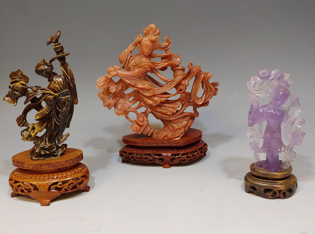 (3) Chinese Stone Carvings of Goddesses: China, 20th century. Group of stone carvings of goddesses with wooden stands. Including: a.) Amethyst carving of a woman holding a lantern and flowers. The figure comes with a wooden stand and an old 