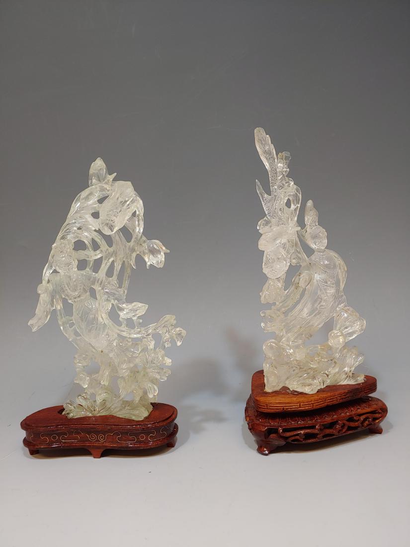 (2) Rock Crystal Carvings of Goddesses: Set of 2 clear quartz or rock crystal carvings of Chinese goddesses. One carving features a goddess, children, and a chilong. The other carving is of a goddess with lotus flowers. They each have a sta