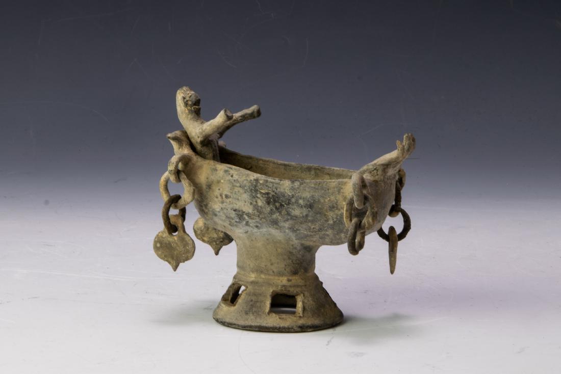 Ancient Korean Figure in Boat Silla Period: Ancient Korean figure in boat dating from the Silla Period. Depicts a person in a boat with ceramic chains and charms hanging from the corners, all resting on a pierced base. Dimensions are: 5 1/2 inc