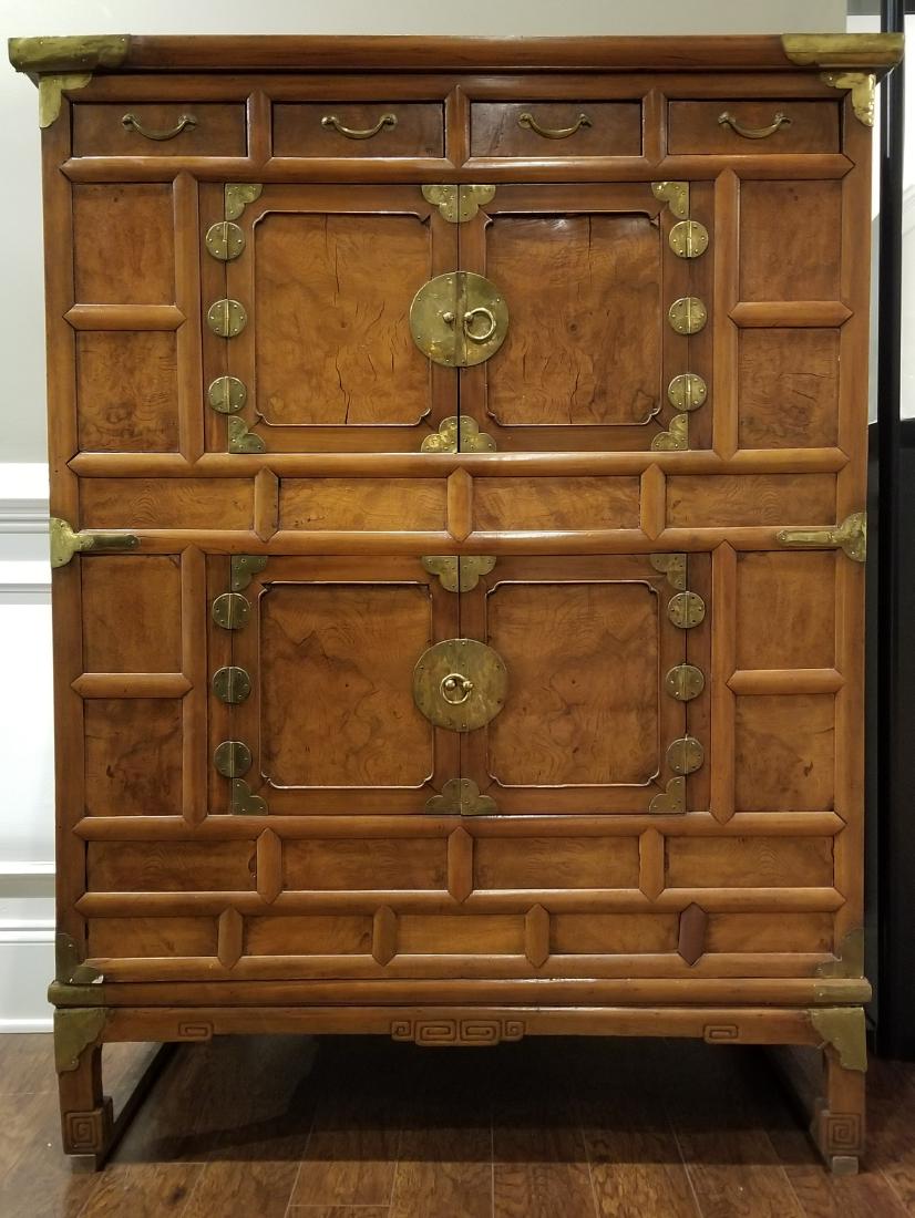 Korean 2-Piece Wood Tansu Chest: Korean 2-piece wood Tansu chest on a raised wooden base, with four drawers over two double doors, each with brass pulls and the chest with brass corners and carved embellishments. The interior lined i