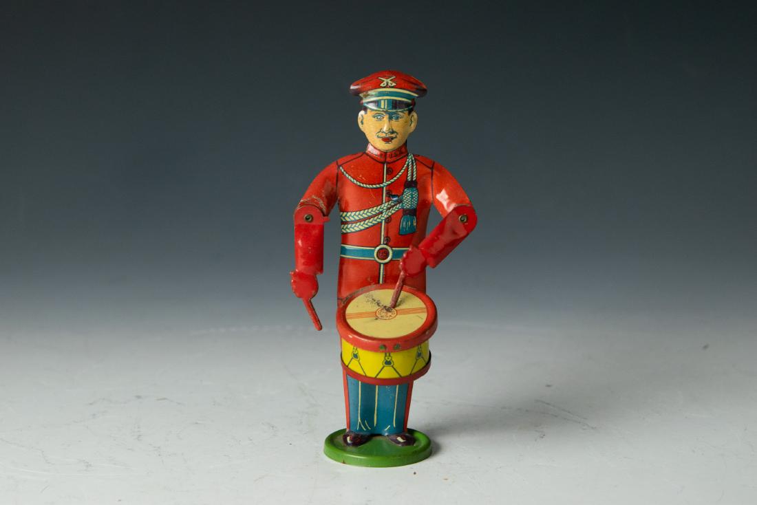 Chein Military Drummer with Plunger Mechanism: Chein tin toy military drummer with plunger mechanism. Mark on drum: J. Chien & Co. Made in USA. Dimensions are: 7 inches high X 3 7/8 inches wide X 2 7/8 inches long. All measurements are approximate