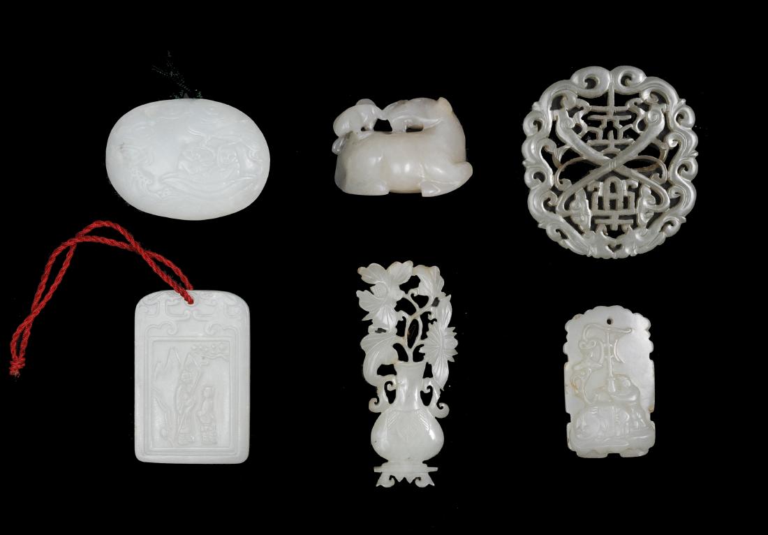 Group of 6 Chinese White Jades, 18-19th Century: A group of 6 Chinese white jade carvings dating from the 18th to the 19th centuries. This lot includes: a 19th century white jade pendant signed "Zigang" with calligraphy carved on 1 side within a dou