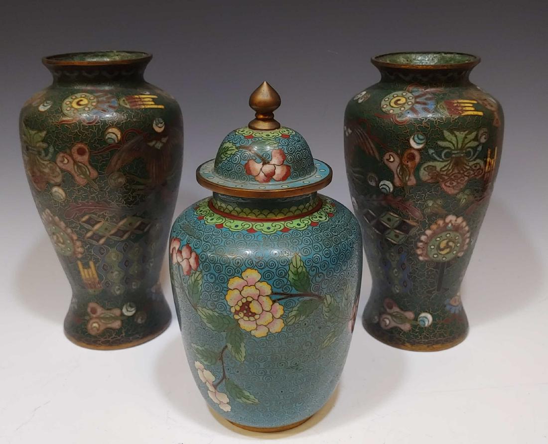 (3) Cloisonne Vases and Cloisonne Urn: (3) Cloisonne Vases and Cloisonne Urn: Includes a matching pair of vases with character marks on the bottom and a lidded jar marked China on the bottom. Dimensions are: each vase - 8 1/ inches tall X