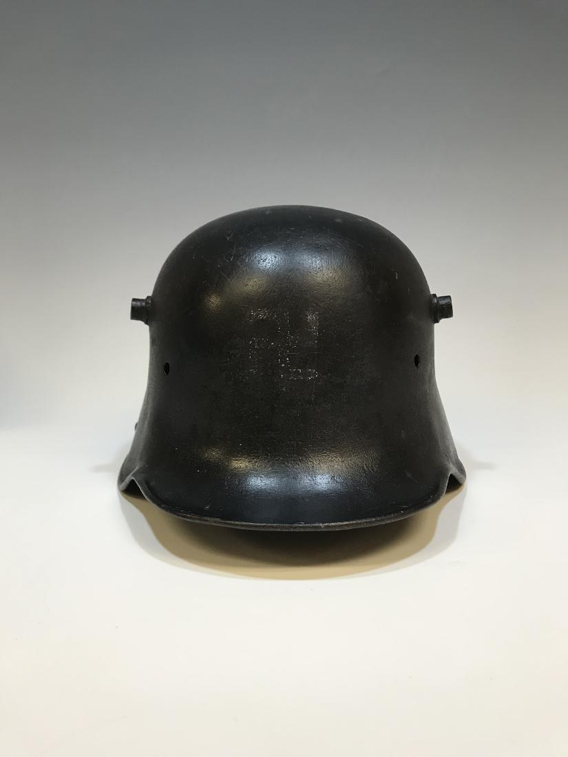 German Imperial WWI M18 Helmet Shell: Repainted German Imperial helmet shell, model M18, from World War I. Dimensions are: 19 1/4 inches wide X 12 1/4 inches long X 6 3/4 inches tall. All measurements are approximate. Condition: Free of b