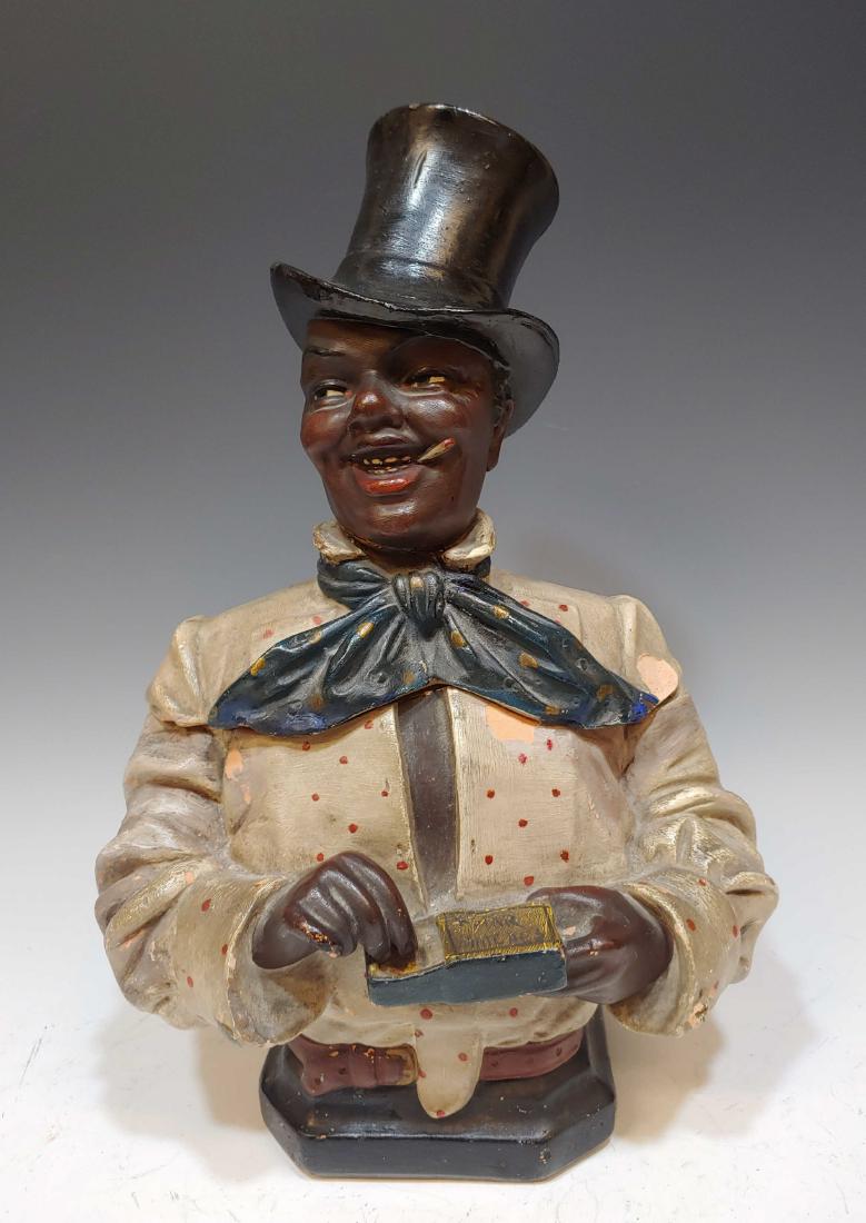 Johann Maresch African American Figural Humidor: In the style of Johann Maresch African American Figural Humidor: A chalk-ware humidor of an African American man with a match box in his hand that reads, 'Star Matches'. There are no visible marks. Di