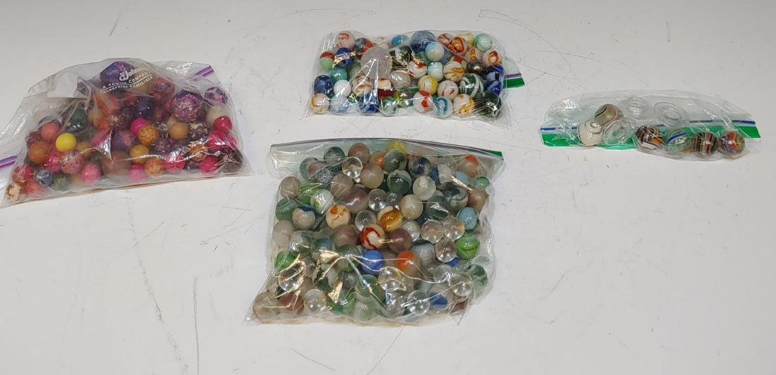 100 + Glass & Clay Marbles inc. Latticinio: Group of 100 + glass & clay marbles, including 3 hand-blown Latticinio core swirl marbles, made in Germany and sold in England as "Bristol Glass," with plastic stands; a hand-blown Joseph's coat swirl
