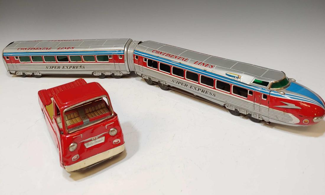 (2) Japanese Tin Toy Truck & Train: (2) Japanese Tin Toy Truck & Train: Train by Yonezawa and Baby trick by Nomura. Dimensions are: baby truck - 3 1/4 inches wide X 7 1/4 inches long X 4 inches tall. All measurements are approximate.