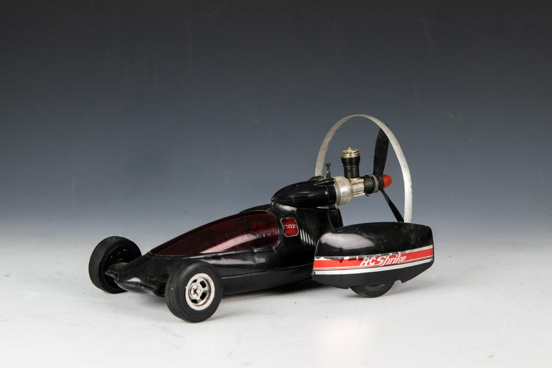 Cox RC Strike Prop-Rod, Black & Red: Gas powered Cox RC Strike Prop-Rod. Body is made out of plastic and the engine is metal, with four rubber tires. Dimensions are: 6 inches wide X 12 inches long. All measurements are approximate.