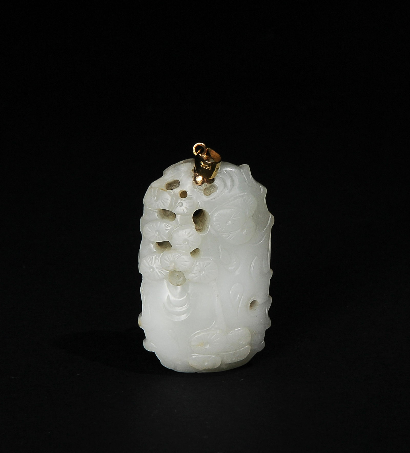 Chinese White & Black Jade Pendant, 18-19th Century: A Chinese white jade plaque carved with bamboo and pine trees with a 14K pendant dating from the 18th century to the 19th century. Dimensions are: 2 inches tall X 1 1/8 inches wide. All measurements a