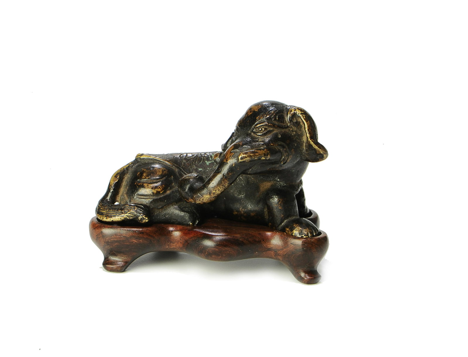 Chinese Bronze Elephant Figurine, Ming Dynasty: A small Chinese bronze figure of an elephant with a wooden stand and dating from the Ming Dynasty. Dimensions are: 1 inches tall X 2 inches wide. All measurements are approximate. Condition: Minor age